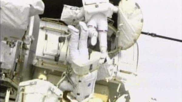 600_iss_spacewalkers_ap_110525 This image taken from NASA television shows astronauts Andrew Feustel, top, and Mike Fincke exiting the hatch on the International Space Station at the start of the second spacewalk early Sunday May 22, 2011. (c) AP Photo/NASA