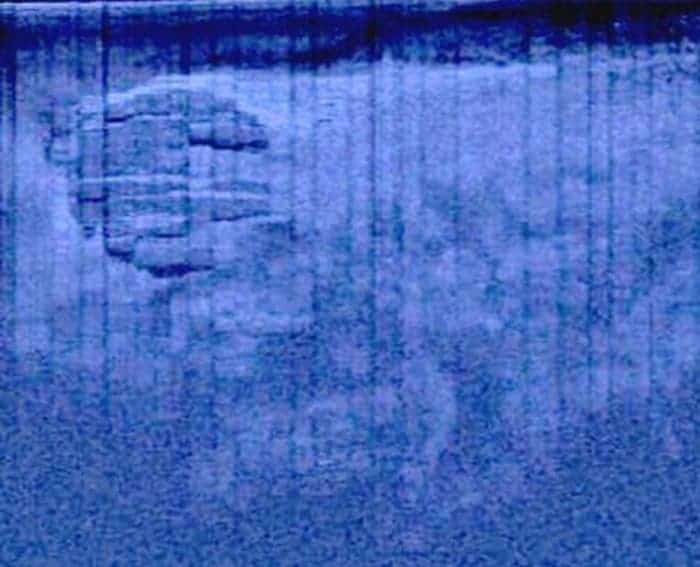The mysterious USO (unidentified sunken object) sonar scan. If you look closer, you'll see some trails leading to it. (c) Ocean Explorer/Peter Lindberg