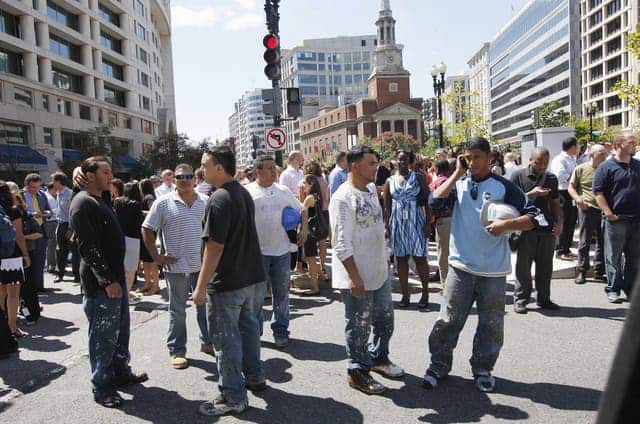 People stand on the streets of Washington, Aug. 23, 2011, after evacuating from buildings following a 5.9 earthquake that hit northwest of Richmond, Va., shaking much of Washington, D.C., and felt as far north as Rhode Island and New York City. (c) Charles Dharapak/AP