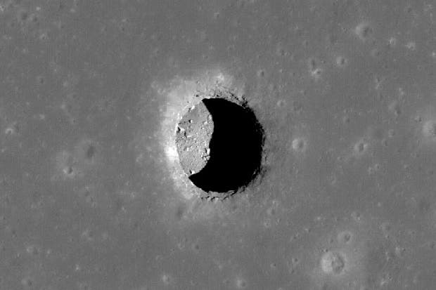 A high resolution image taken by NASA's LROC shows a 100m deep cave inside the moon's surface. (c) NASA