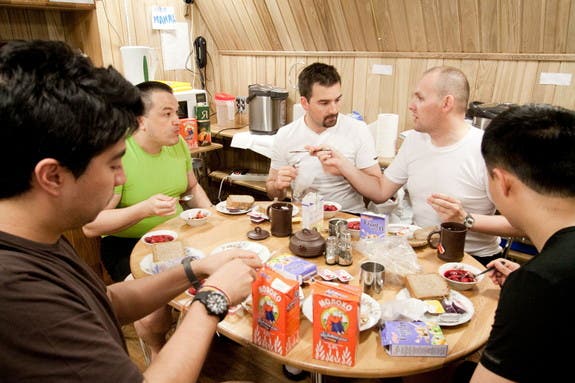 The Mars500 crew share a meal together. Curiously enough, no space food was served and cereal isn't floating either. (c) ESA/Mars500 crew