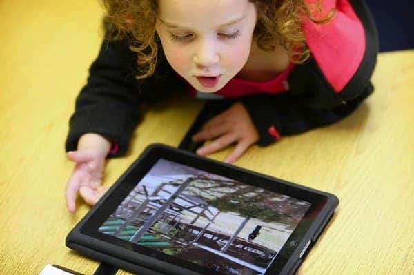 Rachel Ross, 4, a preschooler at Burley Elementary School, uses the iPad with other students in the classroom as the class looks at pictures of classrooms in Australia on Wednesday April 27, 2011.  (William DeShazer/ Chicago Tribune) B581231575Z.1 ....OUTSIDE TRIBUNE CO.- NO MAGS,  NO SALES, NO INTERNET, NO TV, NEW YORK TIMES OUT, CHICAGO OUT, NO DIGITAL MANIPULATION...