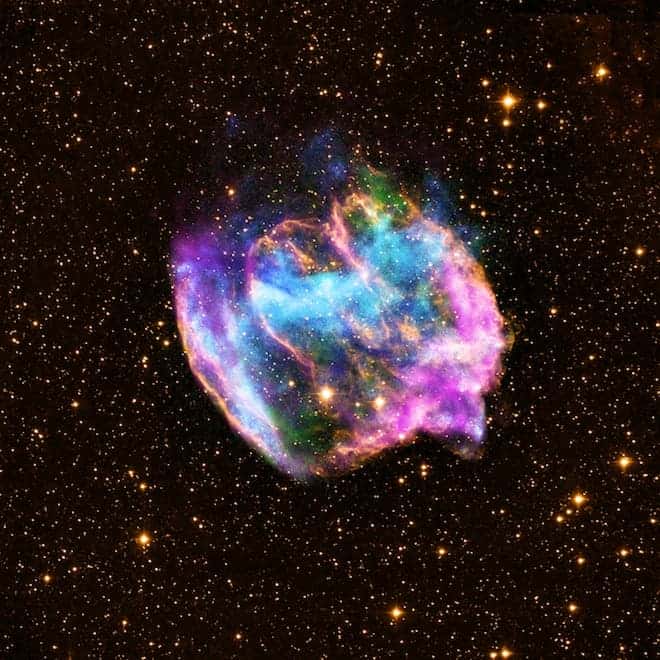 This highly distorted supernova remnant may contain the most recent black hole formed in the Milky Way galaxy. The composite image combines X-rays from Chandra (blue and green), radio data from the Very Large Array (pink), and infrared data from the Palomar Observatory (yellow). (c) NASA