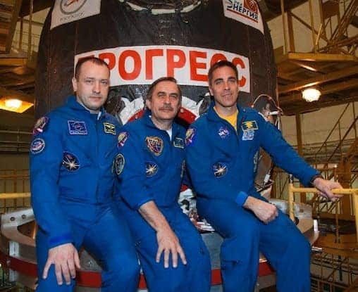 Flight Engineer Alexander Misurkin (left), Soyuz Commander Pavel Vinogradov (center) and Flight Engineer Chris Cassidy of NASA pose for pictures in front of the ISS Progress 51 cargo ship being prepared for launch to the International Space Station on Friday. (Photo: Victor Zelentsov/NASA)