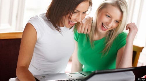 2 girls using computer online