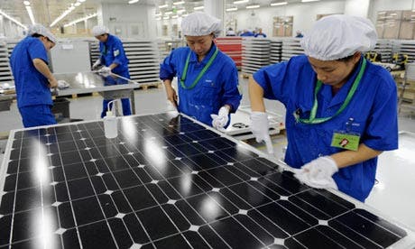 (c) Employees inspect solar panels at a factory in Hangzhou, Zhejiang province. Photograph: Lang Lang/Reuters