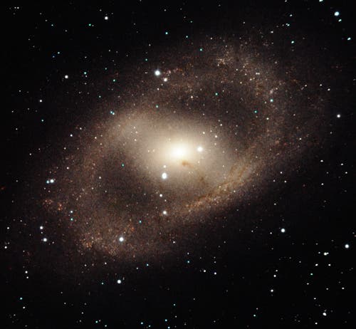 NGC 6300 is an intriguing barred spiral galaxy in the constellation of Ara. This near-infrared image with FLAMINGOS-2 shows the galaxy’s complex arm structure forming a spectacular ring of star formation. The galaxy’s bar also has a strong vein of dust that almost obscures its bright active nucleus –– whose prodigious energy is the result of matter accreting onto a black hole with an estimated mass of 280,000 Suns. Field of view: 3.1 x 2.9 arcmin. Credit: Gemini Observatory/AURA