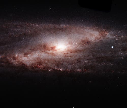 In this near-infrared image, FLAMINGOS-2 peered deep into the heart of spiral galaxy NGC 253, which lies about 11.5 million light-years nearby in the constellation of Sculptor. The new instrument captured an intricate whirlpool of dust spiraling in to a diffuse nuclear region, where violent star formation may be occurring around a supermassive black hole. The instrument also imaged a dusting of star forming sites in its spiral arms. Field of view: 4.8 x 4.1 arcmin. Credit: Gemini Observatory/AURA
