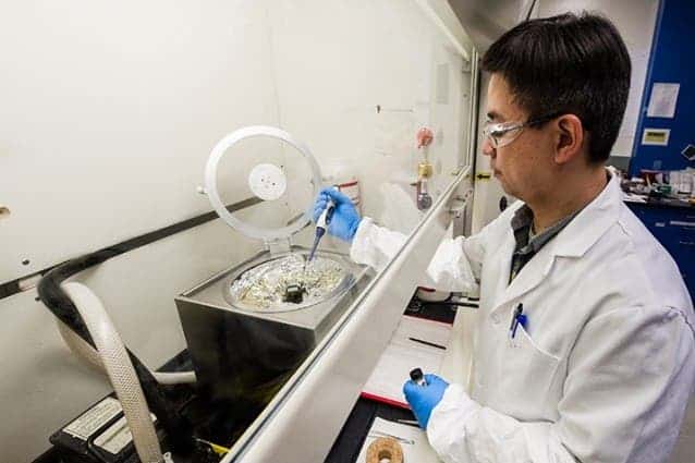 NREL Senior Scientist Kai Zhu prepares a perovskite solar cell in his lab. Photo: NREL