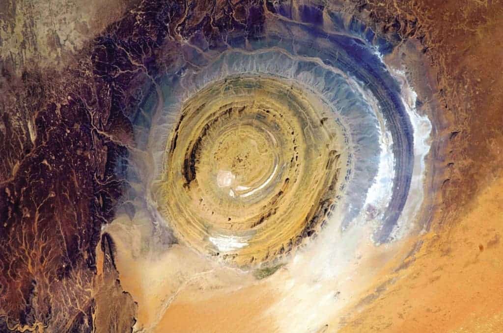 The Richat Structure in Mauritania, also known as the Eye of the Sahara, is a landmark for astronauts. If you’ve been busy doing experiments and haven’t looked out the window for a while, it’s hard to know where you are, especially if you’re over a vast 3,600,000-square-mile desert. This bull’s-eye orients you, instantly. Oddly, it appears not to be the scar of a meteorite but a deeply eroded dome, with a rainbow-inspired color scheme.