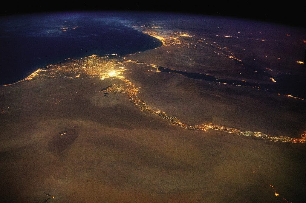 The Nile, draining out into the Mediterranean. The bright lights of Cairo announce the opening of the north-flowing river’s delta, with Jerusalem’s answering high beams to the northeast. This 4,258 mile braid of human life, first navigated end-to-end in 2004, is visible in a single glance from space.