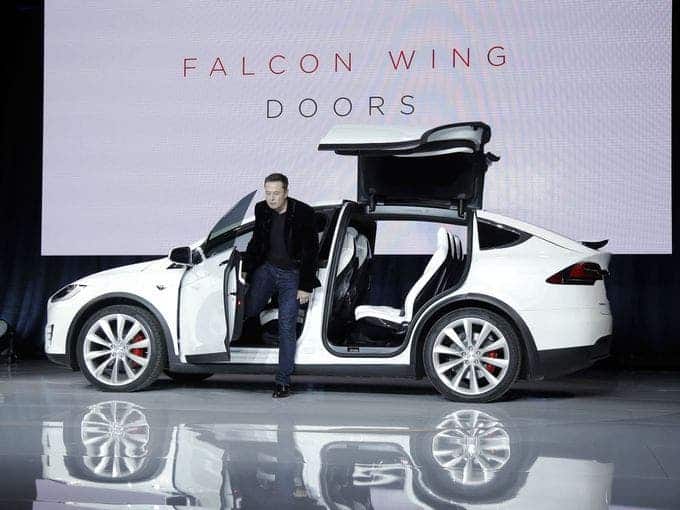 Elon Musk stepping out of the Model X. Image: AP/Marcio Jose Sanchez