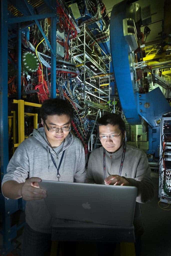 Zhengqiao Zhang, a graduate student from the Shanghai Institute of Applied Physics, with STAR physicist Aihong Tang at the STAR detector of the Relativistic Heavy Ion Collider (RHIC). Credit: Brookhaven National Laboratory antimatter. 