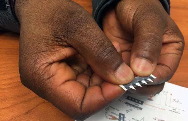 Abraham Badu-Tawiah holds a prototype test strip for diagnosing diseases including cancer and malaria. Photo by Pam Frost Gorder, courtesy of The Ohio State University.