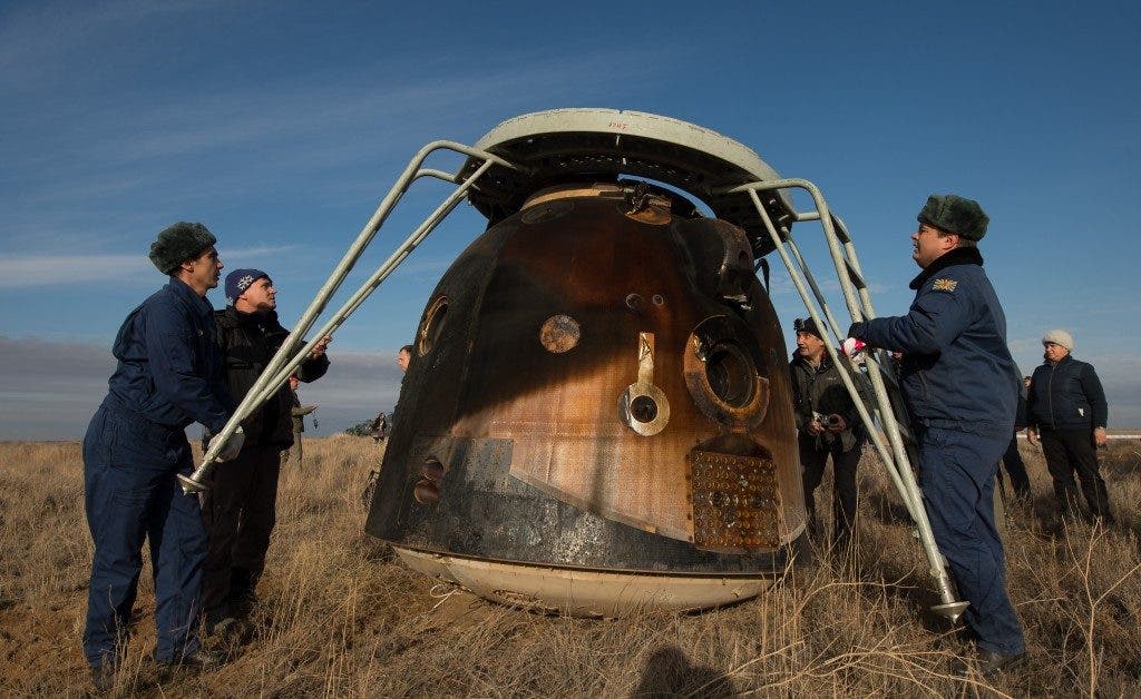 A battered Soyuz craft from the atmospheric re-entry with the crew still inside, shortly before the hatch was opened and the astronauts touched Earth for the first time in 115 days. Credit: Bill Ingalls/NASA