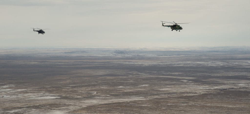 Russian search and rescue helicopters survey the drop site in anticipation for the astronauts' landing. Credit: Bill Ingalls/NASA