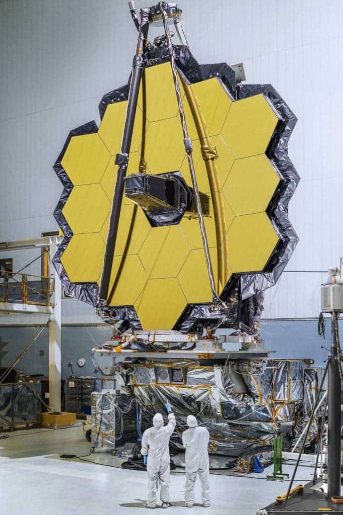 The primary mirror of NASA's James Webb Space Telescope consisting of 18 hexagonal mirrors looks like a giant puzzle piece standing in the massive clean room of NASA's Goddard Space Flight Center in Greenbelt, Maryland. Credit: NASA