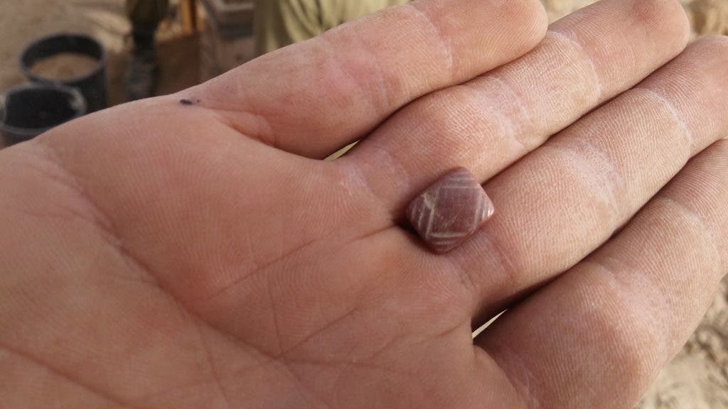 Seal made of carnelian found in the cave. Credit: Casey L. Olson and Oren Gutfeld, Hebrew University. 