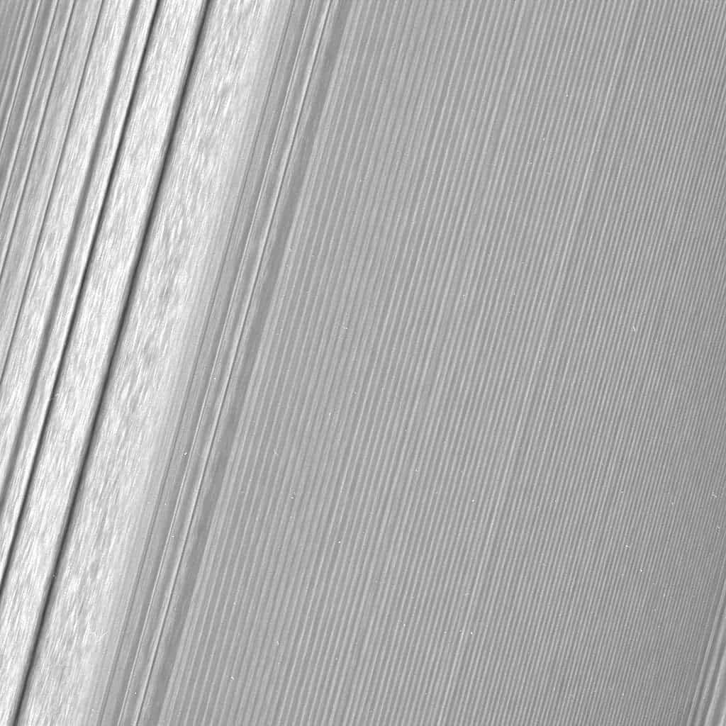 This Cassini image features a density wave in Saturn's A ring (at left) that lies around 134,500 km from Saturn. Density waves are accumulations of particles at certain distances from the planet. This feature is filled with clumpy perturbations, which researchers informally refer to as "straw." The wave itself is created by the gravity of the moons Janus and Epimetheus, which share the same orbit around Saturn. Elsewhere, the scene is dominated by "wakes" from a recent pass of the ring moon Pan. Credit: NASA