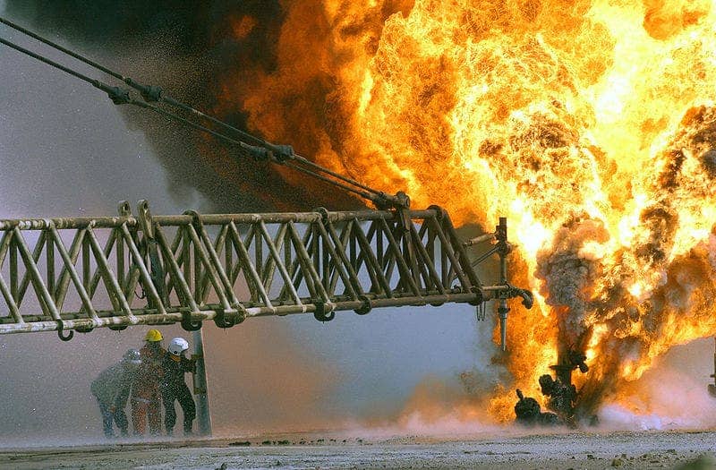 A burning oil well in the Rumaila oilfields, Kuwait.