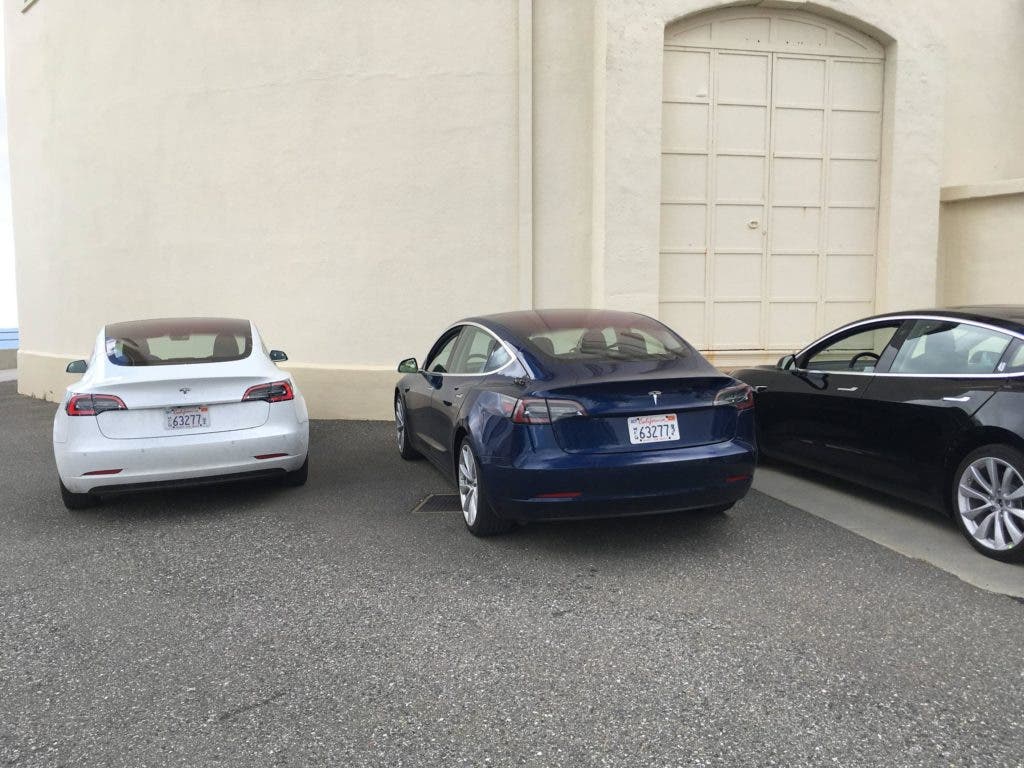 White, blue, and black Model 3s of an unknown version (not production). Credit: Credit: 'inamachineshop' Reddit user