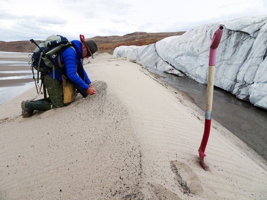 Kurt Kjær collecting sediment samples from the crater's dranage system. Credit: Natural History Museum Denmark.