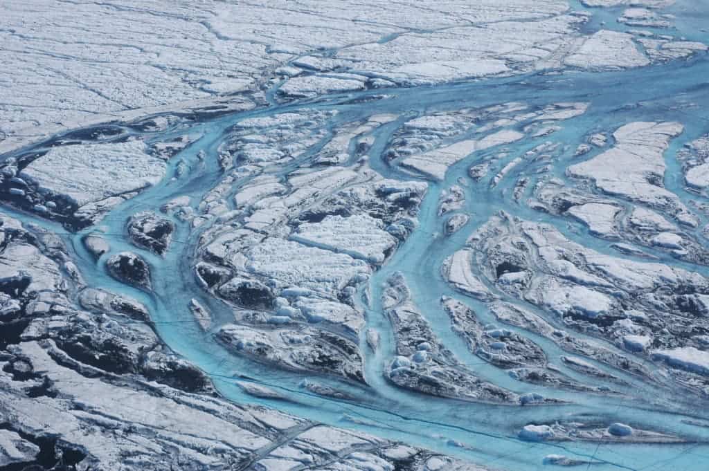 Meltwater slides off Greenland's massive ice sheet into the ocean during hot summer days. Credit: Woods Hole Oceanographic Institution.