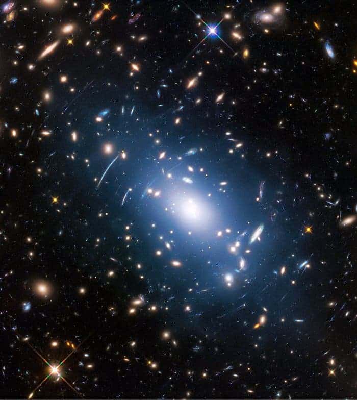 Abell S1063, a galaxy cluster, was observed by the NASA/ESA Hubble Space Telescope as part of the Frontier Fields programme. The huge mass of the cluster — containing both baryonic matter and dark matter — acts as cosmic magnification glass and deforms objects behind it. In the past astronomers used this gravitational lensing effect to calculate the distribution of dark matter in galaxy clusters. Credit: NASA, ESA, and M. Montes (University of New South Wales, Sydney, Australia).