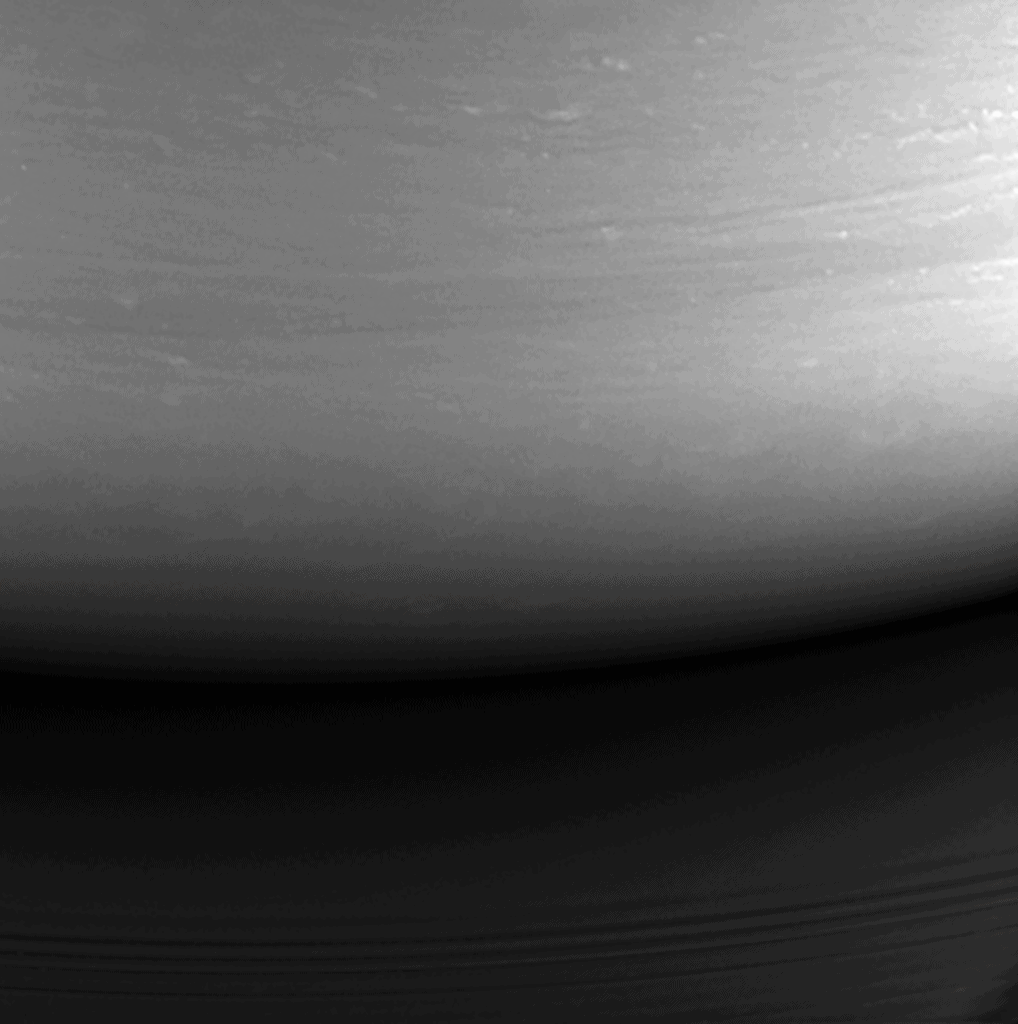 This monochrome view is the last image taken by the imaging cameras on NASA's Cassini spacecraft. It looks toward the planet's night side, lit by reflected light from the rings, and shows the location at which the spacecraft would enter the planet's atmosphere hours later. Credit: NASA/JPL-Caltech/Space Science Institute.