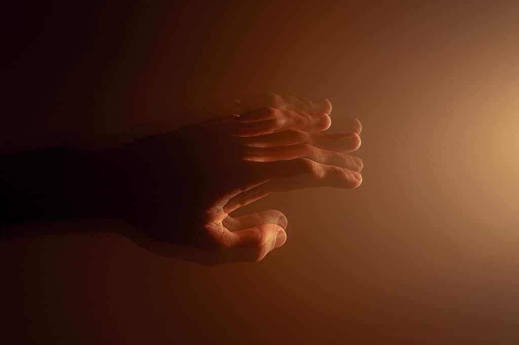 Trembling hand illustrating Parkinson's.