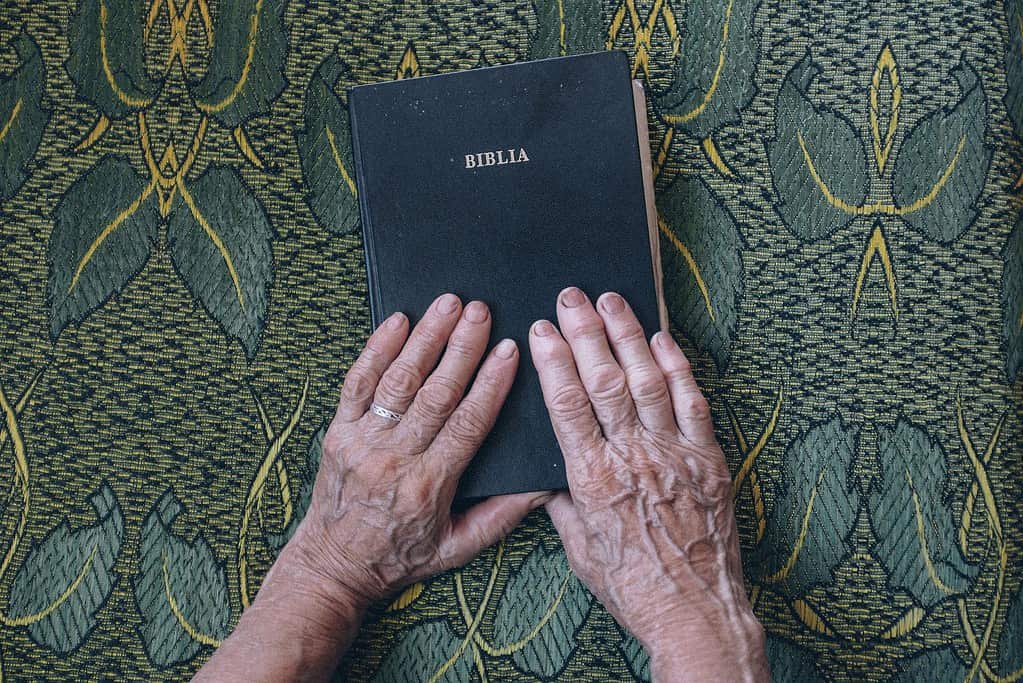 Picture of the bible with human hands